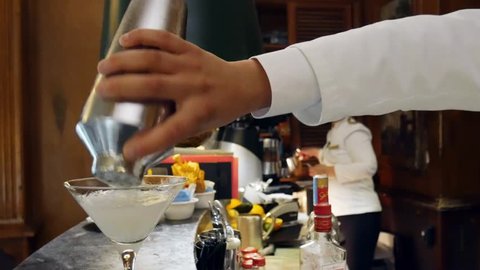 Estoril, Portugal - April 9th, 2019: Bartender prepares a cocktail at the Spies Bar within the Hotel Palacio, frequented by spies during WWII, as well as Ian Fleming, creator of James Bond