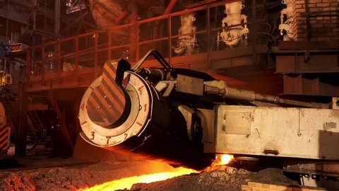 Molten steel in high temperature melting at the metallurgical plant. Stock Footage. Steel production in electric furnace that moving slowly towards the camera.