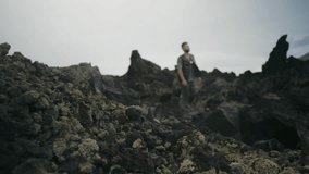 Caucasian man walking among rocks in mountains, enjoying beautiful landscape, solitude and peace - Powered by Shutterstock - Get 15% off with code: PIKWIZARD15