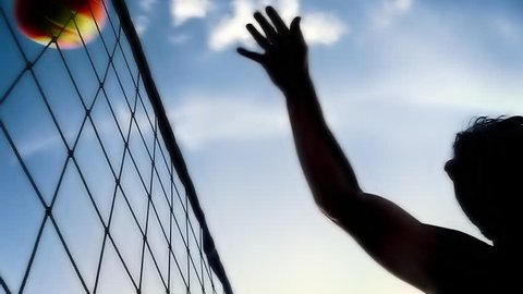 Silhouette of man hitting volleyball spike closeup 
