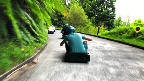 footage filmed in the well known luge in Rotorua, New Zealand. People having fun, no face, only from behind.