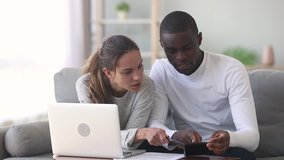 Serious multiethnic young couple discuss pay domestic bills on laptop at home interracial family planning expenses using calculator computer app managing budget money calculating finances taxes - Powered by Shutterstock - Get 15% off with code: PIKWIZARD15