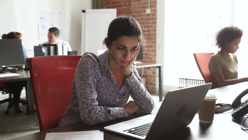 Bored sad indian worker tired unmotivated and disinterested in dull work with laptop paperwork, lazy female hindu employee feeling lack of motivation, annoyed with boredom in office and boring job | Shutterstock HD Video #1027488407