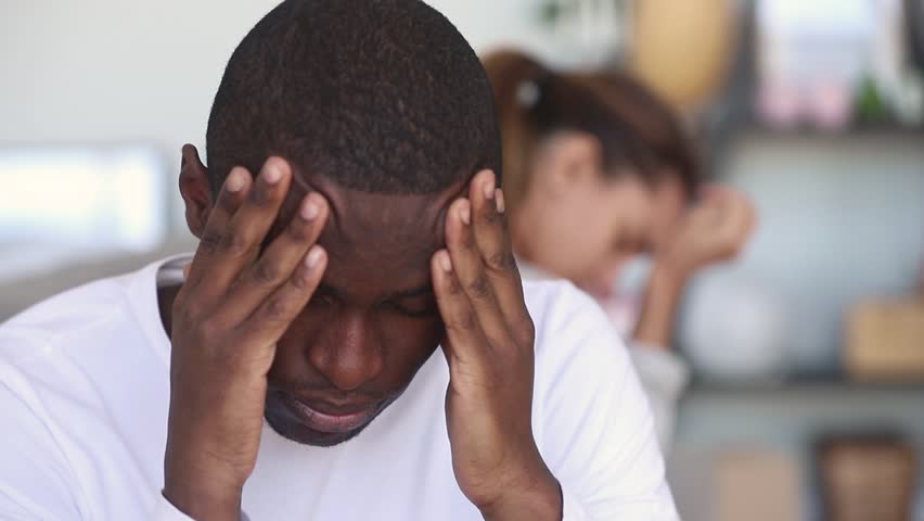 Sad thoughtful african american man feel upset after fight with girlfriend, upset depressed black husband tired of argument think of bad marriage, jealousy distrust in interracial couple relationship