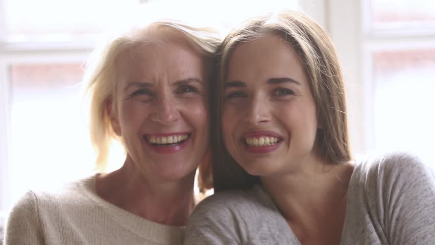 Happy beautiful loving family old mature mother and adult daughter laughing bonding looking at camera, smiling senior mom with young woman having fun enjoy connection and warm relationships, portrait | Shutterstock HD Video #1027488470