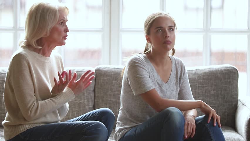 Stubborn annoyed young adult daughter turned back not listening ignoring worried stressed old senior mother arguing scolding lecturing, two different age generation women family having fight conflict Royalty-Free Stock Footage #1027488527
