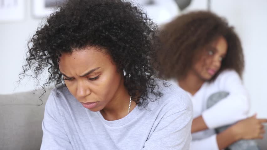 Angry upset african american mother sister feeling sad after conflict with teen daughter, depressed single black parent mum of teenage girl offended by child ignoring each other, family fight concept