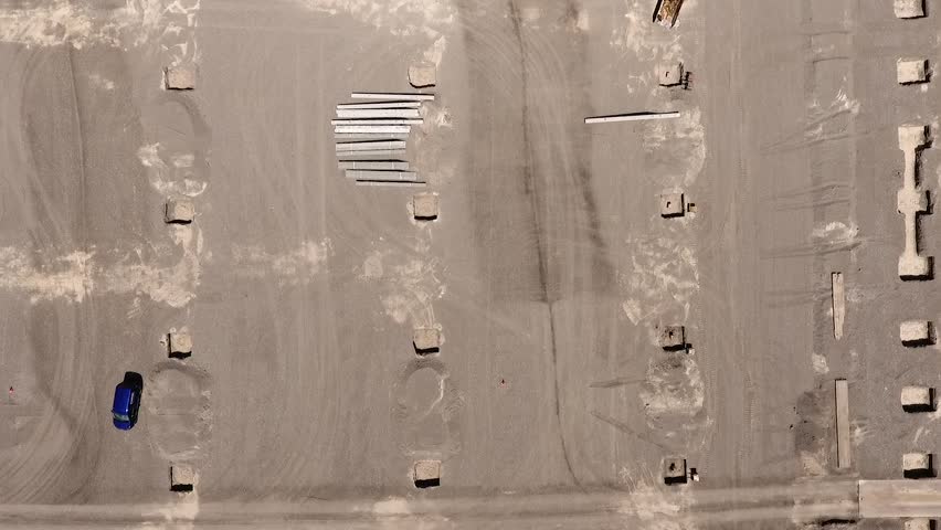 Zooming out of a contruction site with a drone that is flying higher and higher.