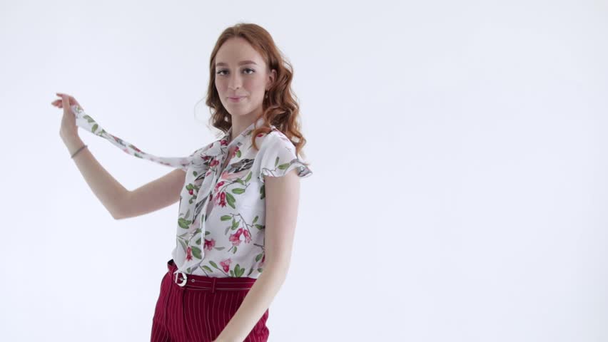 Sexy model with red hair posing on white background, slow mo