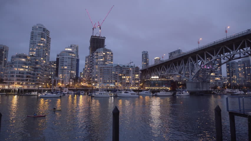 Two kayakers near Yaletown shoot from Granville Island at Night