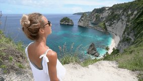 Young woman contemplating idyllic beach from above - Travel destinations vacations people wonderlust concept nature scenics- Girl enjoys tropical beach holidays 