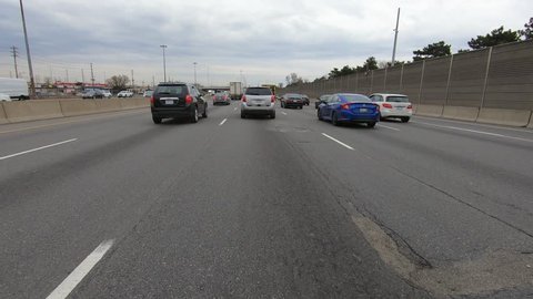 Toronto, Ontario, Canada April 2019 Driving plate POV on highway with car and truck traffic in Toronto