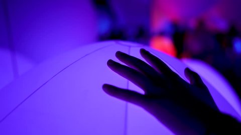 Cinematic Hand Touching Glowing Colorful Ball Changing Colors Bokeh at Mori Digital Art Museum Teamlab Borderless in Tokyo, Odaiba, Japan.