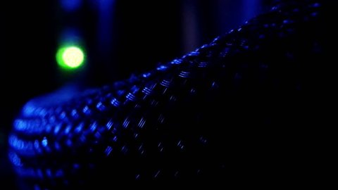 Mesh power cable inside a computer leading to a green LED. Isolated panning shot taken on a slider.