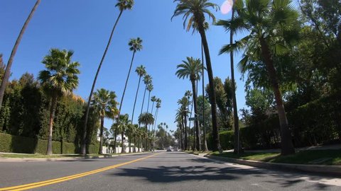 Drive through the Palm tree Alleys of Beverly Hills - LOS ANGELES. UNITED STATES OF AMERICA - MARCH 18, 2019