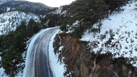 Cars traveling on treacherous icy road through Flatiron mountains in Colorado, Aerial view
