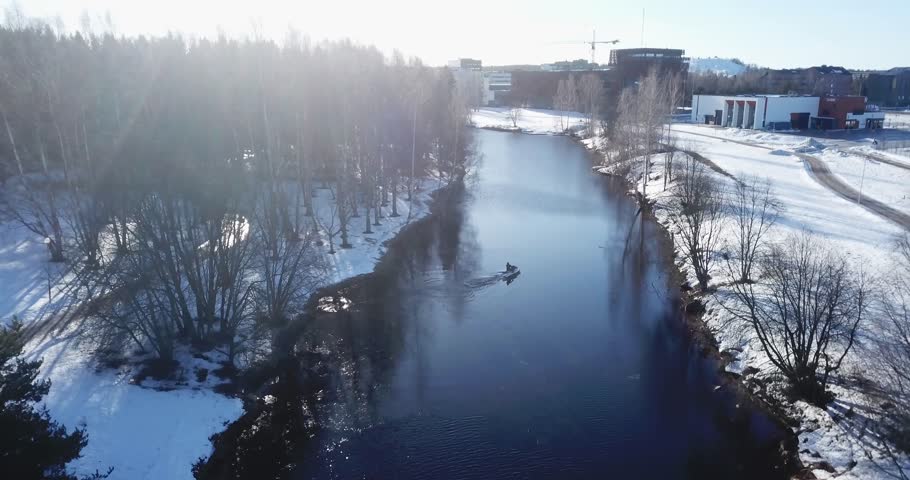 Aerial: Wakeboarding in an icy river in winter, Seinäjoki Finland! Royalty-Free Stock Footage #1027534958