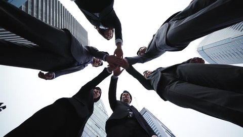 Group of businessperson forming a circle. Teamwork of business concept. Low angle view.