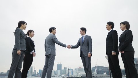 Group of businesspersons shaking hands.