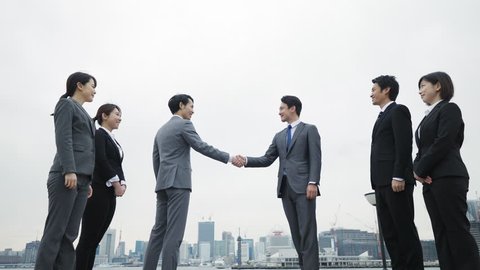 Group of businessperson shaking hands.