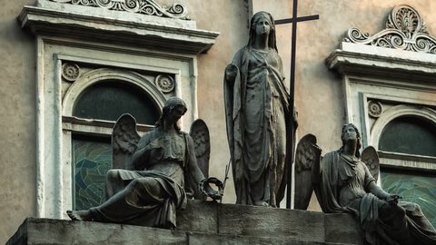 MILANO,ITALY-9 OCTOBER,2018: Old Italian monument in the city streets of Milano,Lombardia.Traditional sculpture in medieval style found in Italy.Angels with crosses in gothic style on building facade