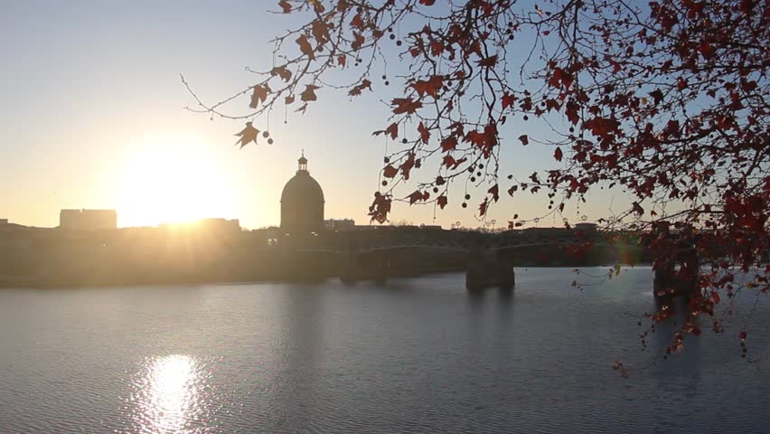 European city with river and a beautiful sunset during winter