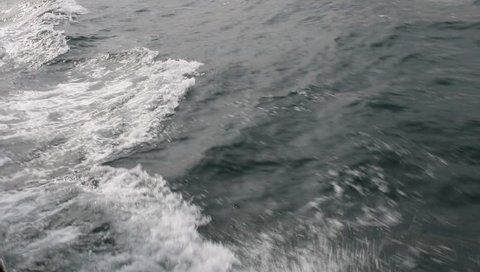 Surface of the dark sea, fastly moving waves  with the ship