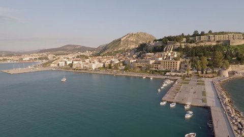 Aerial shot flying above city towards castle hill in Nafplio, Greece