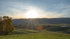 This video is a timelapse of the sun setting behind the mountains on a farm in Lewisburg, West Virginia in fall time.