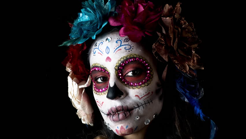 Beautiful woman with custom designed candy skull mexican day of the dead face make up