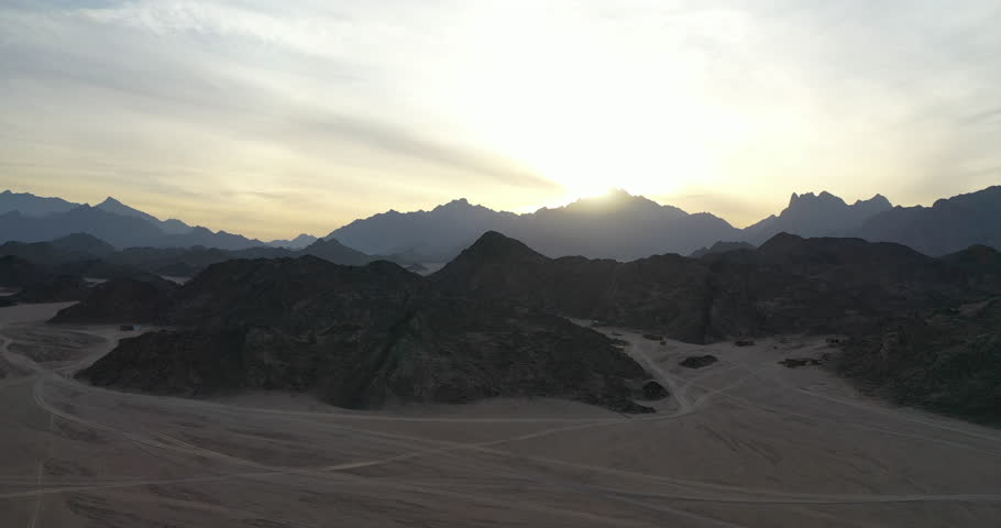 Aerial view of sunset over the mountains in the desert of Egypt. Drone shot.