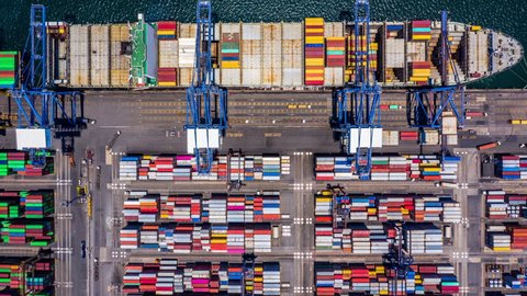 Container ship loading and unloading at port, Aerial view business logistic import and export freight transportation by container cargo ship, Container loading cargo freight shipping, Time Lapse, 4K.