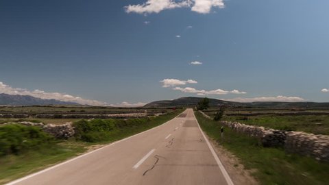 POV shot from a camera attached to the front of an off road vehicle driving along roads in Pag island, croatia