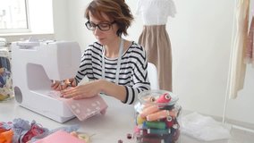 Small business and hobby concept. Fashion designer working on her designs in the bright studio