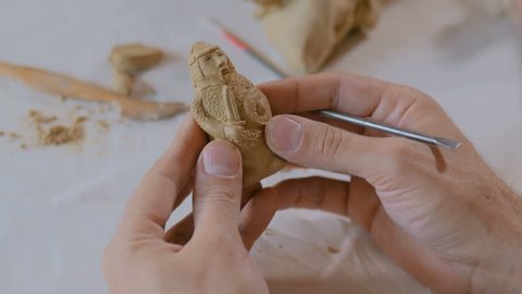 Professional male potter making clay figure for medieval popular strategy board game - tafl. Handwork, crafting and traditional arts concept ஸ்டாக் வீடியோ