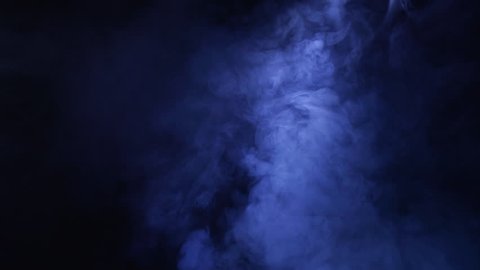 Smoke in slow motion on black background. ?olor smoke slowly floating through space against black background.