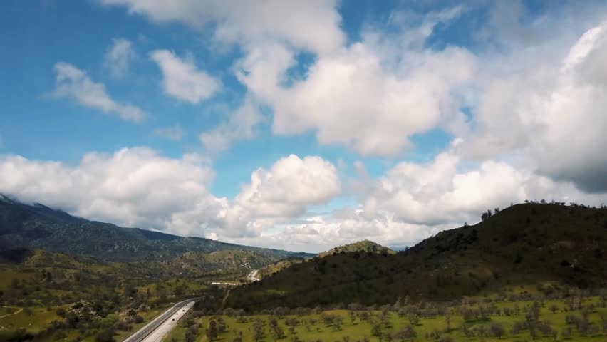 Aerial, Picturesque highway winding through California foothills on cloudy day