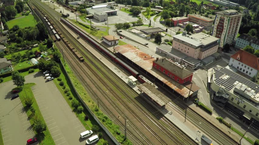 Passenger train leaves the station in Kapfenberg, Austria. Aerial 