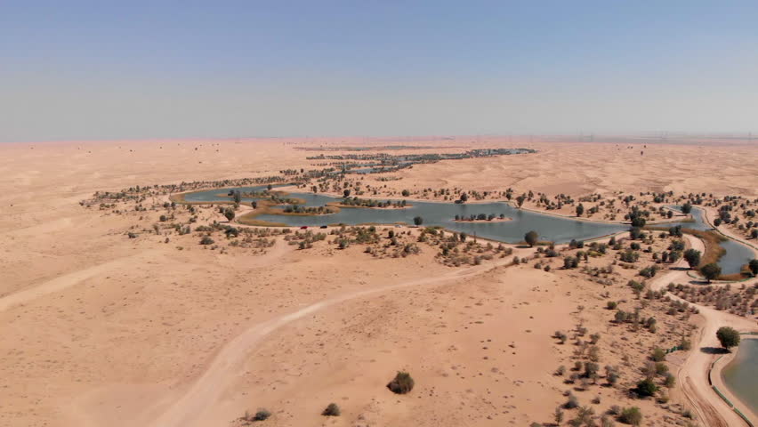 Aerial shot of the manmade lakes of Al Qudra Dubai UAE Desert Oasis Royalty-Free Stock Footage #1027607138