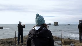 Attractive Young Woman Explores Icelandic Coastline.