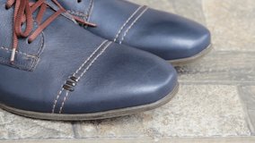 Blue men's shoes against the background of a stone, sports shoes for a businessman
