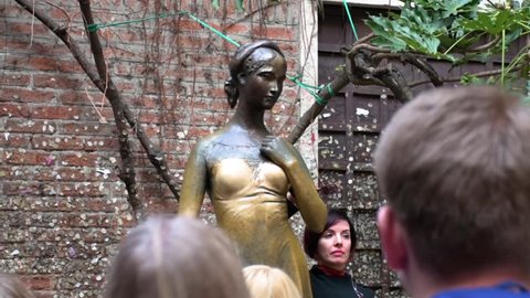 VERONA, ITALY, 19 MARCH 2019 : People visiting the bronze statue of Juliet and Juliet's balcony in Verona
