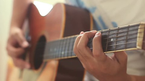 Man practicing guitar with slow motion shoot music musician classic chord acoustic free time holiday summer. Use for illustration or insert.