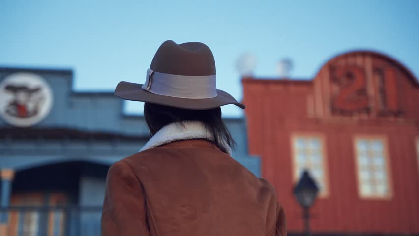Beautiful young girl in a hat outdoors