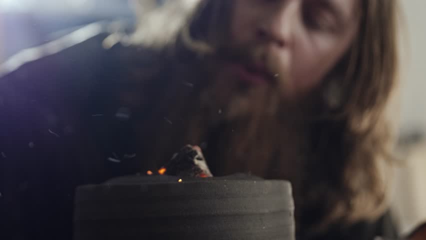 Tea master preparing hot coals for tea ceremony