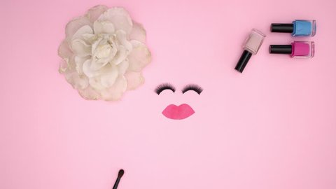 Make up and woman's accessories and eye lashes blinking on pink background- Stop motion animation video Stock Video