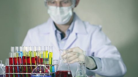 Laboratory scientist working at lab with test tubes.