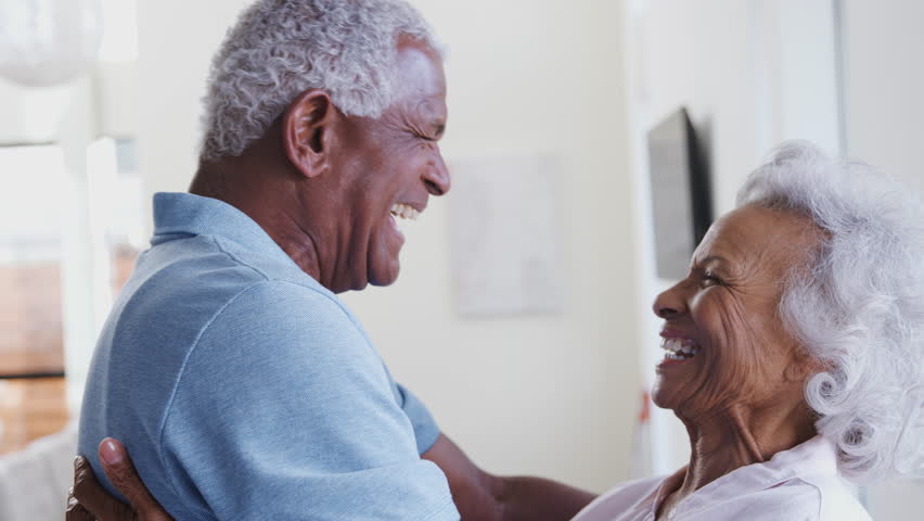 Profile Shot Loving African American Senior Couple Hugging At Home Together | Shutterstock HD Video #1027623200