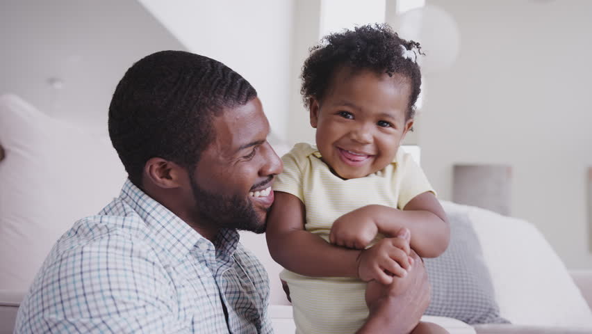 African American Father Playing With Baby Daughter Tickling Her At Home | Shutterstock HD Video #1027623482