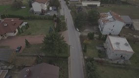 View from the top down to the European village. A small village in the suburbs of Warsaw. Top view over the houses surrounded by green lawns. Drone shot 4k. Video format RAW.